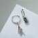 Earrings with the rhinestones "keychain" Eiffel Tower, white color in silver