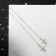 Hanging earrings with rhinestones “cross” on a chain, white color in gold, 10.3 cm