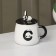Ceramic mug with a lid and spoon "Panda", 450 ml, white and black color