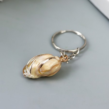 Keychain plastic "shell in a cage" with gold 3x2x1.2 cm-1