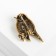 Brooch "Bird" Voruski, green color in black gold