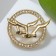 Brooch "Birds" in a circle, white color in gold