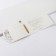 Invitation to a wedding with a golden ribbon, carved, white