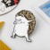 Hedgehog icon hype, white-brown color in ferrous metal