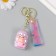 A keychain plastic, rubber with a carbine, a rosel strap of pink 3x3.5x5 cm