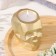 Candle "Skull" in a candlestick of gypsum with faces, 6x9x6.5cm, gold
