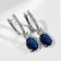 Earrings with rhinestones "blitz", white-blue color in silver