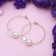 Busin-roller earrings with a rhombus, d = 6 cm, white color in gold
