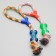 A training cable toy with a bone, up to 120 g, up to 40 cm, mix of flowers