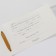 Invitation to a wedding with a golden ribbon, carved, white