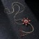 The pendant "Flower" is magical, white-red color in gold, 70 cm