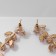 Hanging earrings with rhinestones "Blink" with leaves, white color in gold, 8 cm