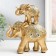 Souvenir Polystone "Golden Elephant with an elephant on the back - circus blanket" 20x5x16 cm