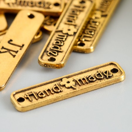 Decorative element "handmade" color gold 2.5x0.6 cm