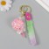 A keychain plastic with a carbine, a strap "Lollipop with a bow" Water with a glitter of 4x4x6.5 cm