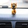 Dog on a car panel shocking his head, Irish Terrier