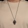 The pendant "Skull with patterns" bright eyes, red color in black silver, 70 cm