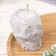 Candle "Skull" in a candlestick of gypsum with faces, 6x9x6.5cm, marble with black stripes