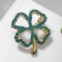 Brooch "Clover" contour, emerald color in gold