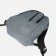 A backpack with a zipper, "saxi", outer pocket, gray color