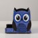 The stand for the office is a wooden owl "owl, winks", with a print, blue