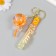 A plastic keychain with a carbine, a strap "Orange" water "water with decor1.8x5.3x5.6 cm