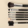 A set of makeup brushes "monogram", 7 objects, a cover on a button, golden color/black