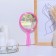 A mirror with a handle, bilateral, with an increase, D mirror surface 12.5 cm, pink color