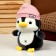 Soft toy "Penguin" with a backpack, in a pink hat, 22 cm