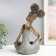 Polystone souvenir "Girl with curly tails, with a dish" under bronze 19x12x27 cm