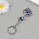 Keychain from the evil eye Metal "petal" 3x3.5 cm