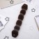 A roller with a mount and an elastic band for creating a bundle 5x22.5 cm, brown