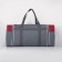 Road bag on a zipper, with an increase, 3 outer pockets, a long belt, the color is gray/red