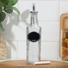 A bottle with a metal dispenser for oil and sauces 