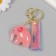 A plastic keychain with a carbine, a pink elephant strap 2.5x5.3x4.5 cm