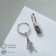 Earrings with the rhinestones "keychain" Eiffel Tower, white color in silver