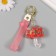 A keychain plastic with a carbine, a strap "Umbrella with a strawberry" Water with a decor 6x5x2 cm