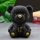 The piggy bank "Bear in the jacket" is black, gold, 19 cm