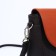 Richet bag on a magnet, a long belt, an orange/brown color