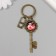 A keychain metal, glass "Castle with a heart and a key with roses" bronze 10 cm