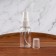 A bottle for storage, with a spray, with a division scale, 30 ml, white/transparent color