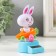 Plastic pendulum from the solar battery "White Bunny in the carrot machine" 5.8x6.5x10.5 cm