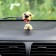 Dog on a car panel shocking his head, Wales Terrier