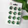 Brooch "Clover", white-green color in gold (indivisible packing 12 pcs., Price per pcs.)