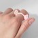 Ring "Montrustrik" ears, white-pink color, dimensionless