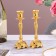 A set of 2 candlesticks, 7 x 7 x 19 cm