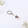 Key keychain “Our love is...”, acrylic, 13.3 x 8
