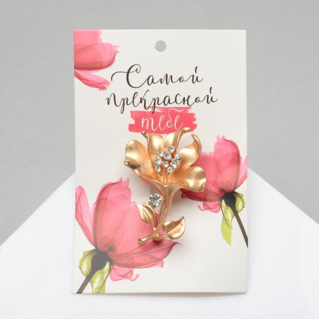 The brooch is “open” flower, white color in matte gold