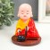 Plastic pendulum from the solar battery "Little Buddha with Cars" 11x8.5x8.5 cm