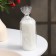 Candle-cylinder with faces, 5x10 cm, white, 6 hours